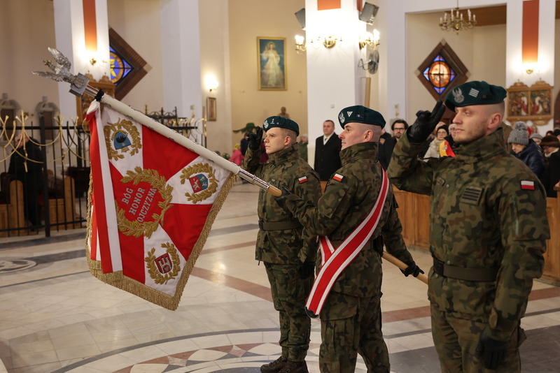 na zdjęciu poczet sztandarowy oddający honor przed ołtarzem w kościele