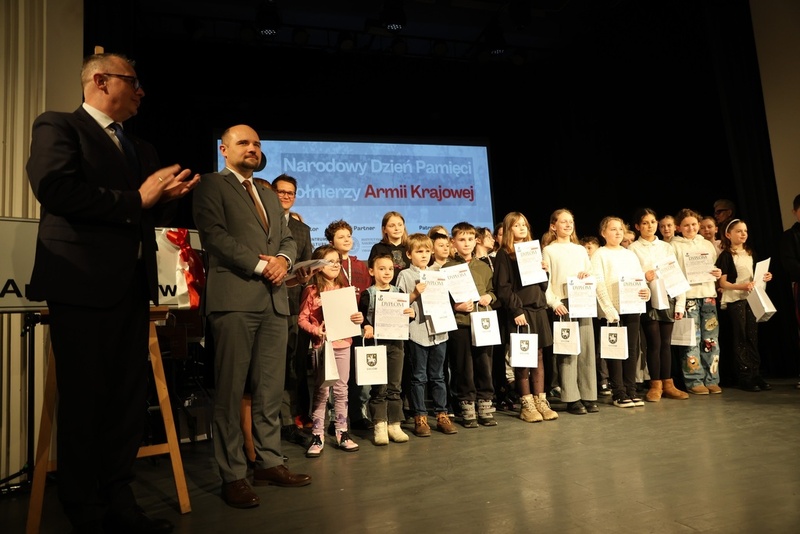 grupowe zdjęcie uczestników konkursu plastycznego. Z lewej strony stoi dyrektor IPN Wrocław