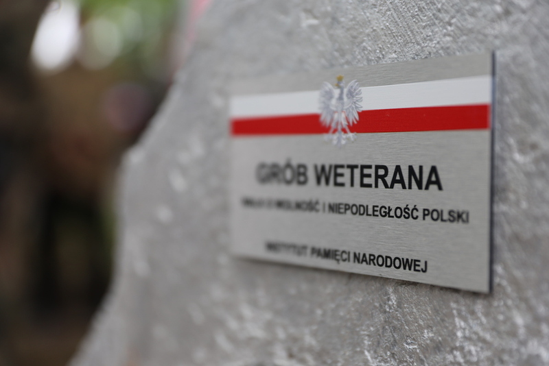 zbliżenie na tabliczkę bohatera która umieszczona jest na grobie